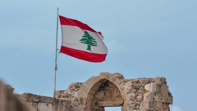 a flag flying on top of a stone structure