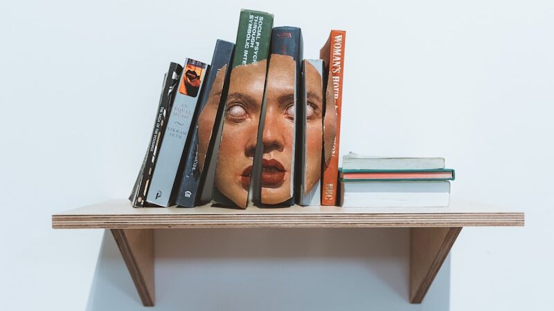 a shelf with books and pens on it